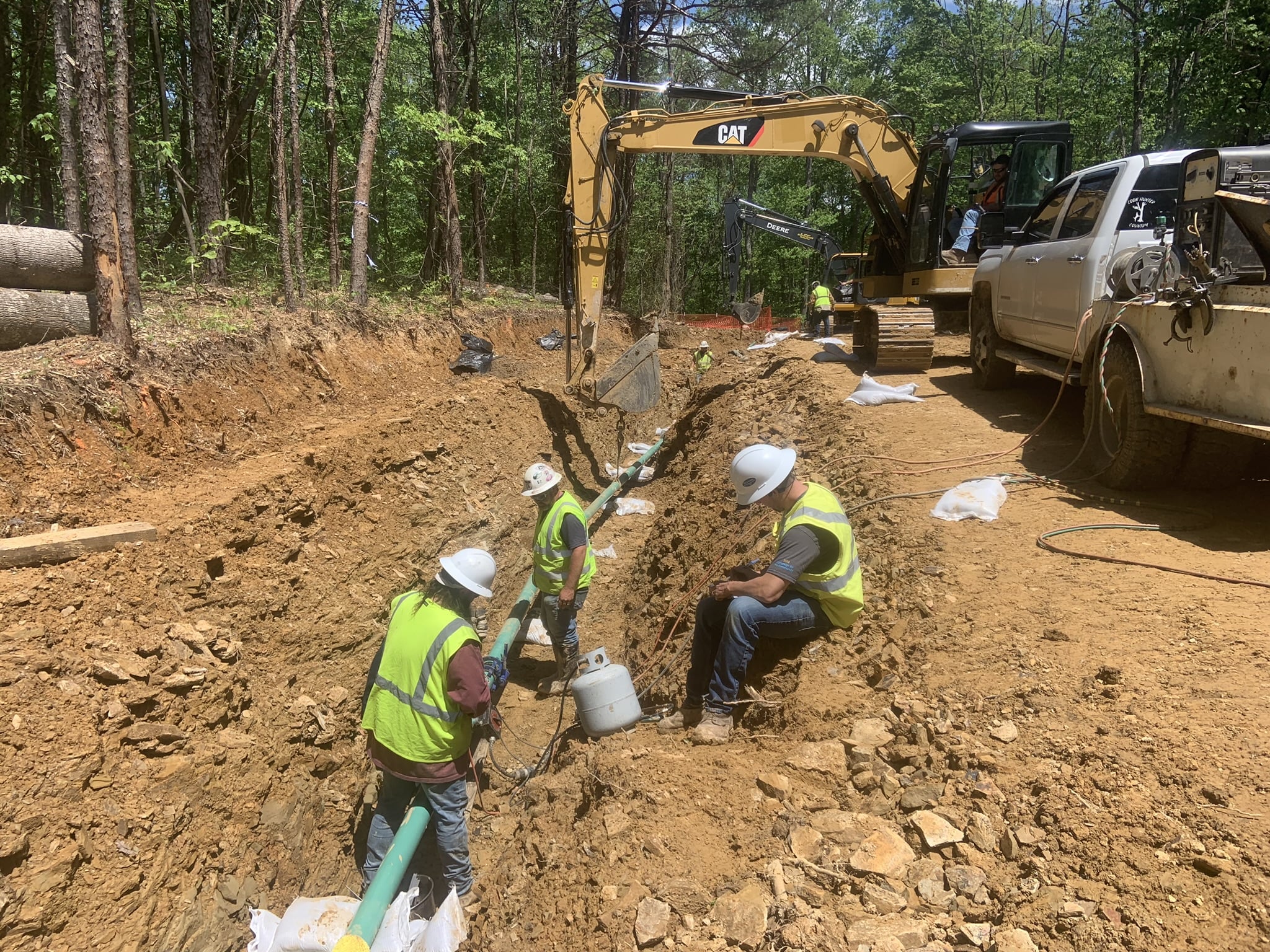 A1 industrial resources pipeline employees working on pipeline project wearing safety gear and testing